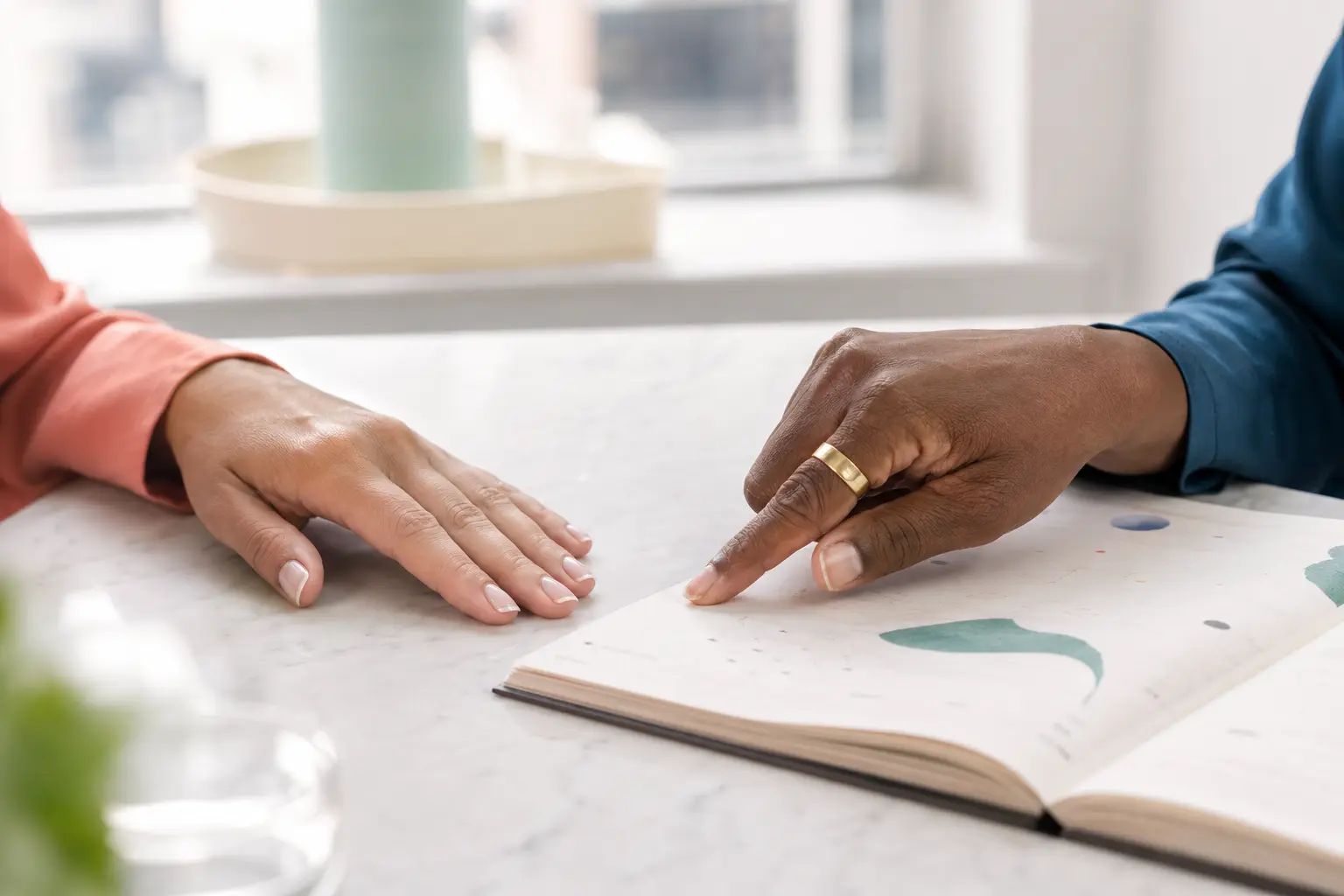 A clinician and patient review a care plan together, with the clinician pointing to a page as they discuss it.